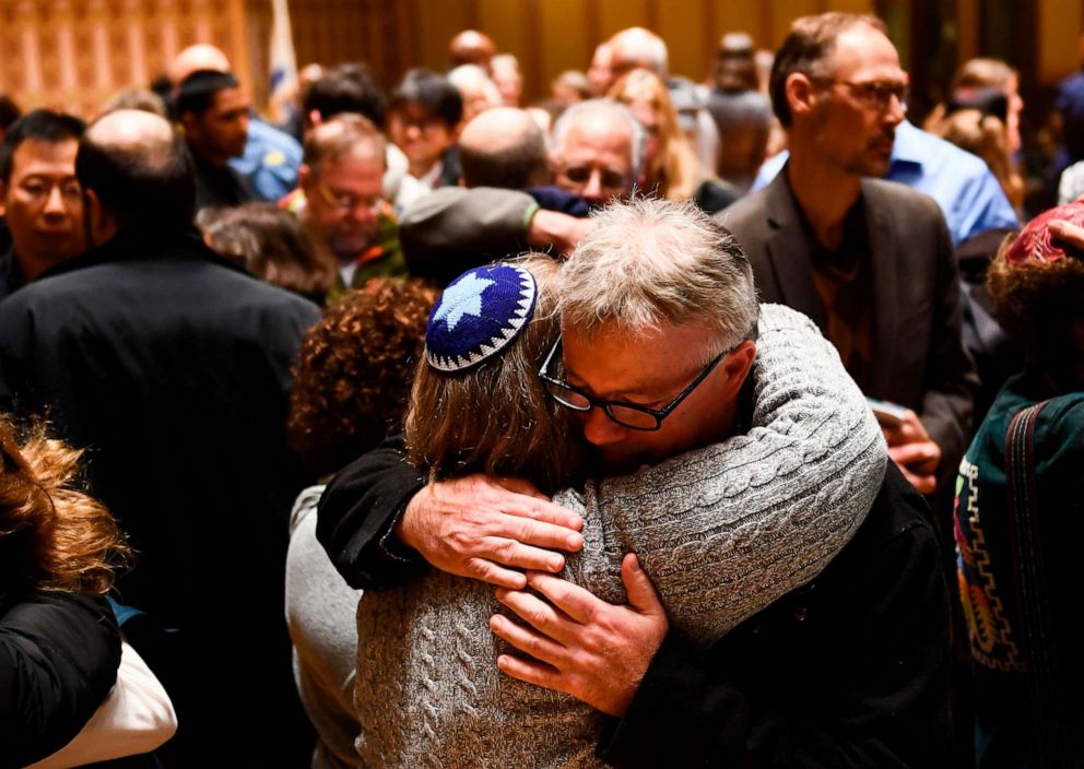 PHOTO: People hug after a vigil, to remember the victims of the shooting at the Tree of Life synagogue the day before, at the Allegheny County Soldiers Memorial, Oct. 28, 2018, in Pittsburgh.