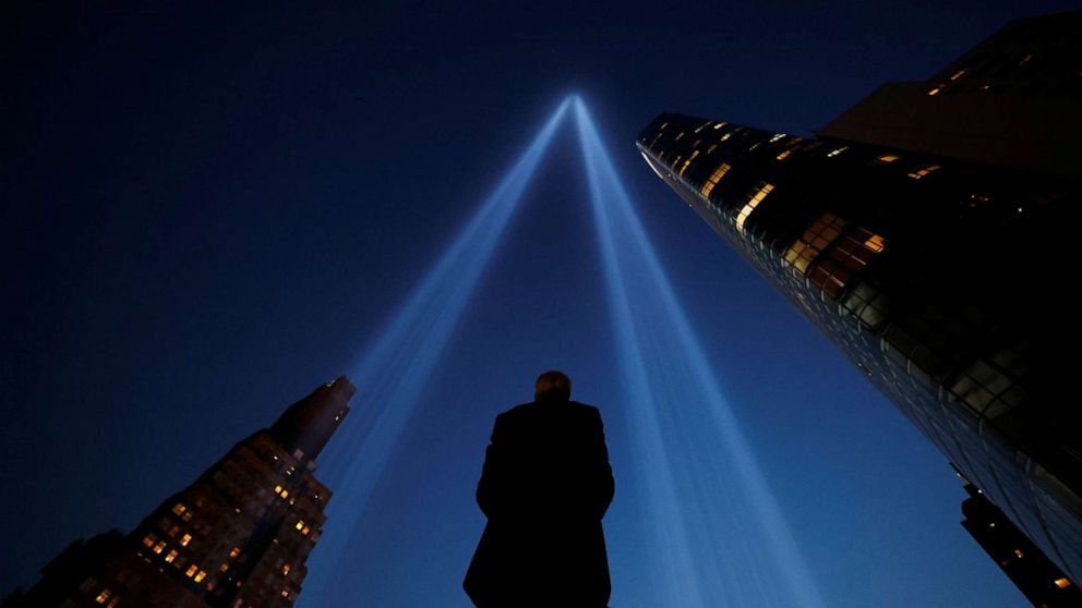 PHOTO: A person takes pictures of the Tribute in Light art installation on the day marking the 20th anniversary of the Sept. 11, 2001, attacks in New York City, Sept. 11, 2021.