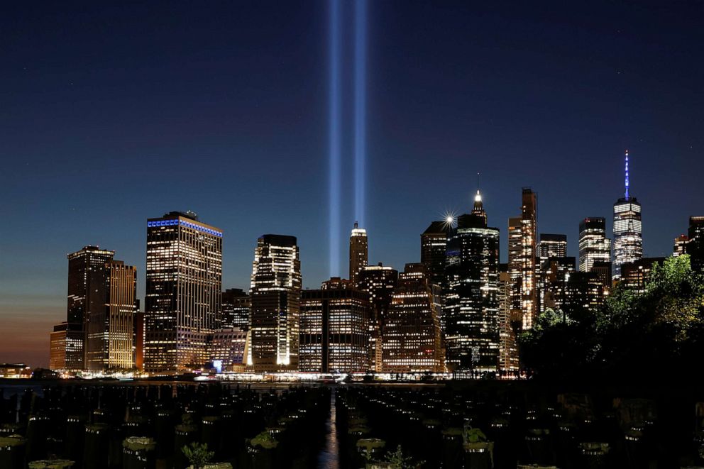 PHOTO: The Tribute in Light installation and One World Trade Center are seen over lower Manhattan on the 20th anniversary of the Sept. 11 attacks, from Brooklyn Bridge Park in New York, Sept. 11, 2021.