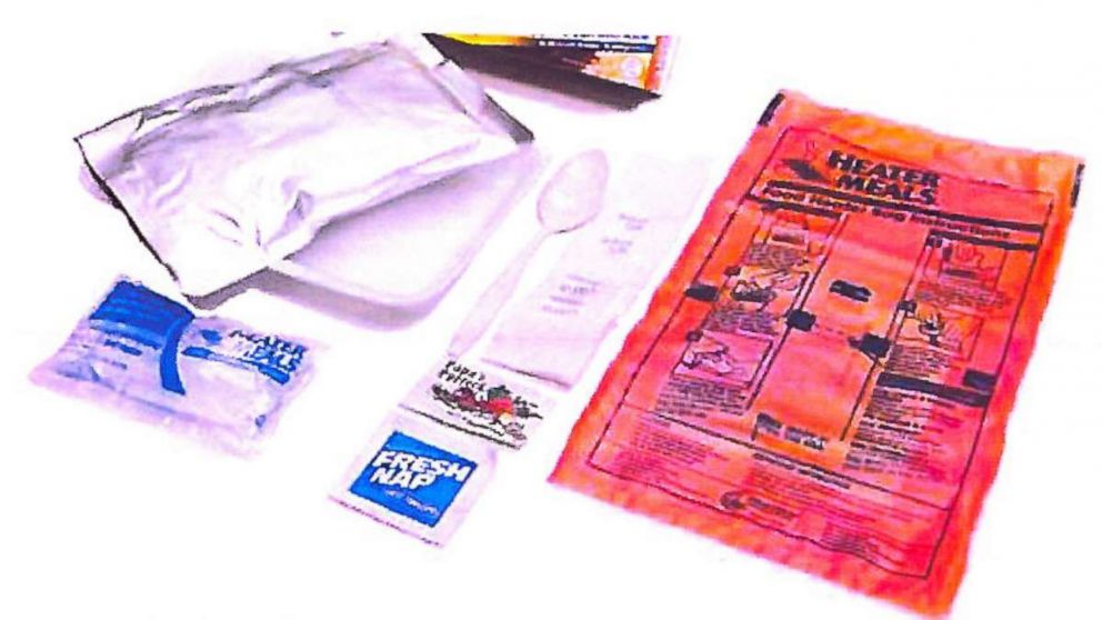 PHOTO: A photo in Tribute Contracting, LLC's contract with a catering company show examples of self heating meals that include a meal in one pouch with a food heater, water pouch, cutlery, and seasonings. 