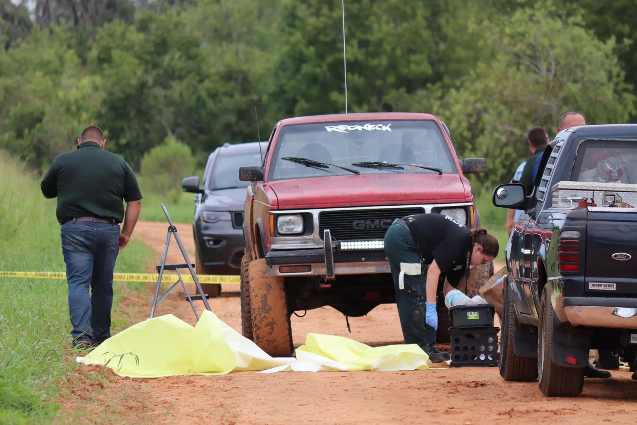 PHOTO: Officials investigate the scene on July 18, 2020, where three people were killed while fishing in Frostproof, Fla., the previous day.