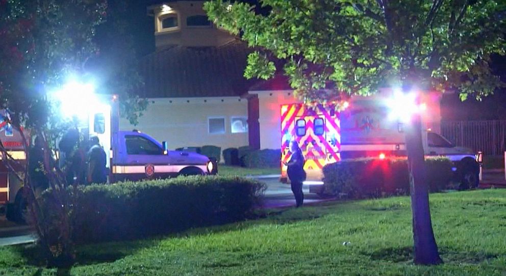 PHOTO: Ambulances sit outside the scene where a 15-year-old boy was hit and killed by a stray bullet while he was playing a video game inside his home in San Antonio, Texas, July 20, 2021.