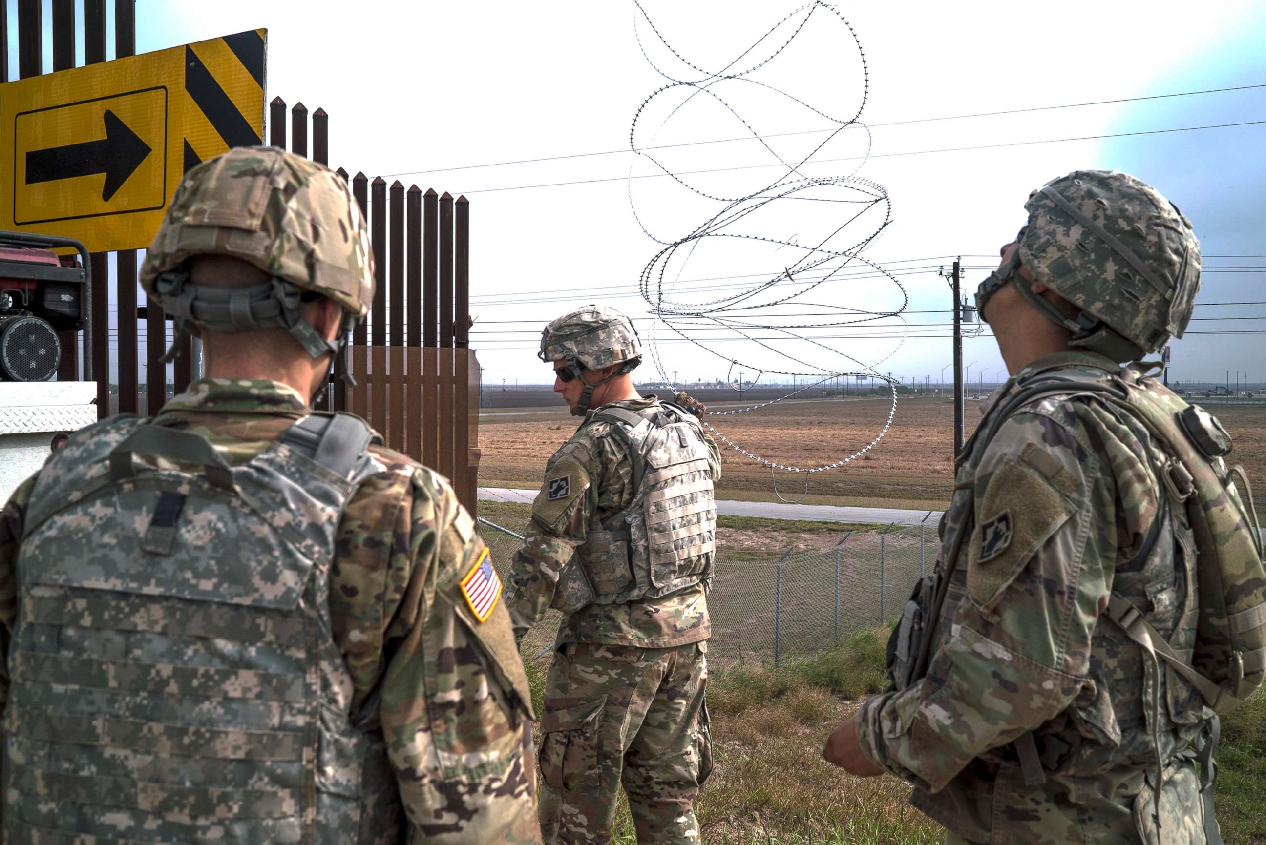 PHOTO: 541st Sapper Company Soldiers use a cherry picker to install concertina wire along the top of the border fence in Donna, Texas, Dec. 1, 2018.