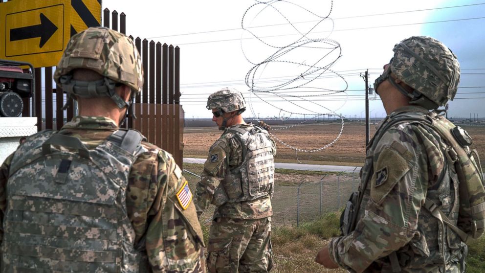 PHOTO: 541st Sapper Company Soldiers use a cherry picker to install concertina wire along the top of the border fence in Donna, Texas, Dec. 1, 2018.