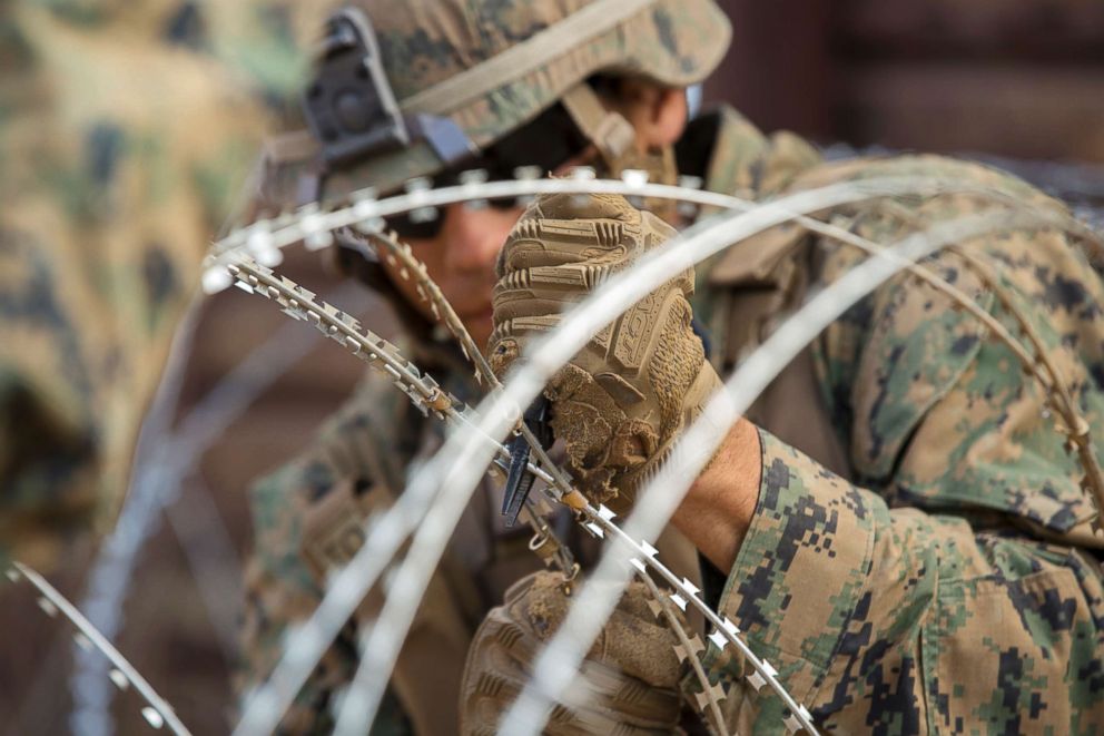 PHOTO: U.S. Marine Corps Matthew Burgett, a combat engineer with 1st Combat Engineer Battalion, Special Purpose Marine Air-Ground Task Force 7, adjusts concertina wire using pliers at the California-Mexico border, Nov. 28, 2018.