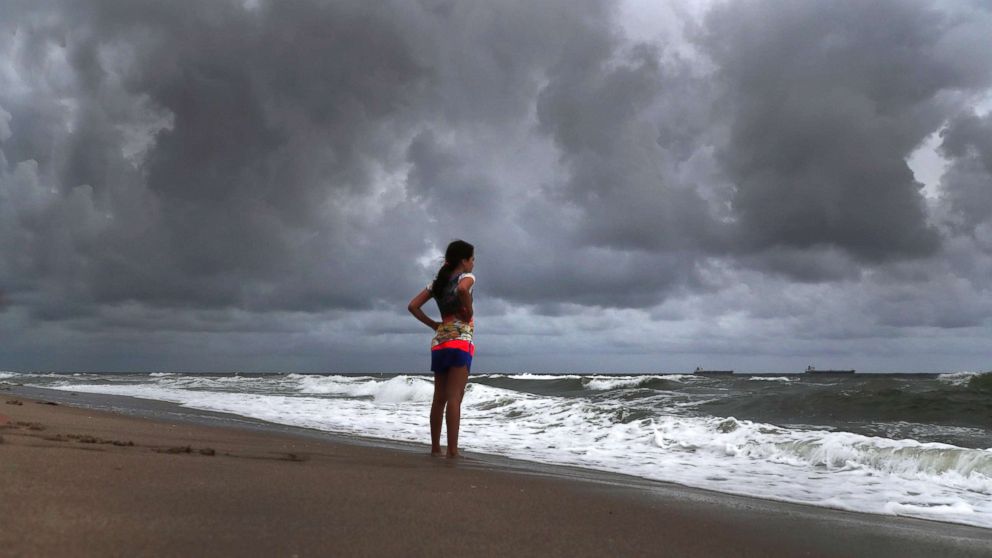 PHOTO: Alicia Herrera,10, visiting from Germany doesn't let dark clouds ruin her day at beach in Fort Lauderdale, Fla., May 25, 2018.
