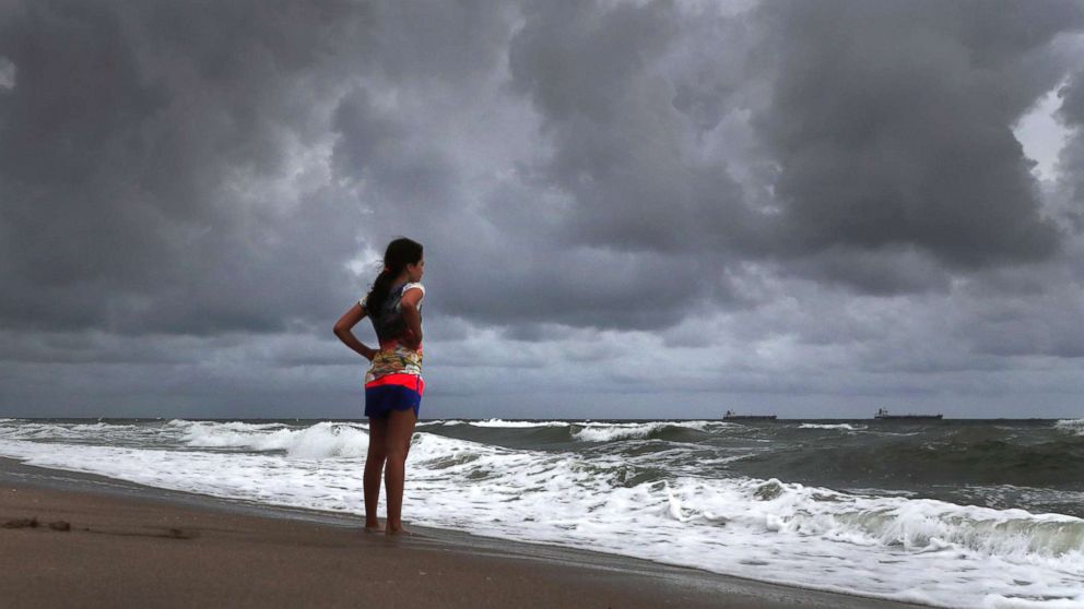 PHOTO: Alicia Herrera,10, visiting from Germany doesn't let dark clouds ruin her day at beach in Fort Lauderdale, Fla., May 25, 2018.