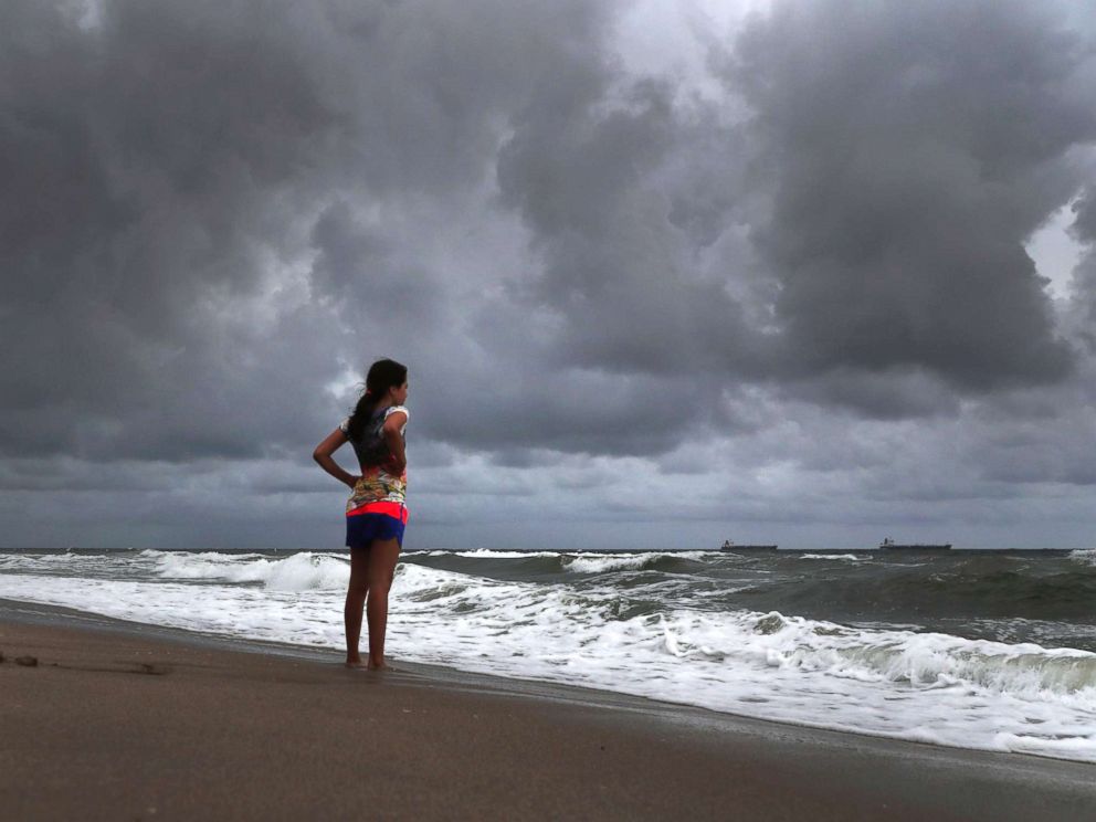 PHOTO: Alicia Herrera,10, visiting from Germany doesnt let dark clouds ruin her day at beach in Fort Lauderdale, Fla., May 25, 2018.