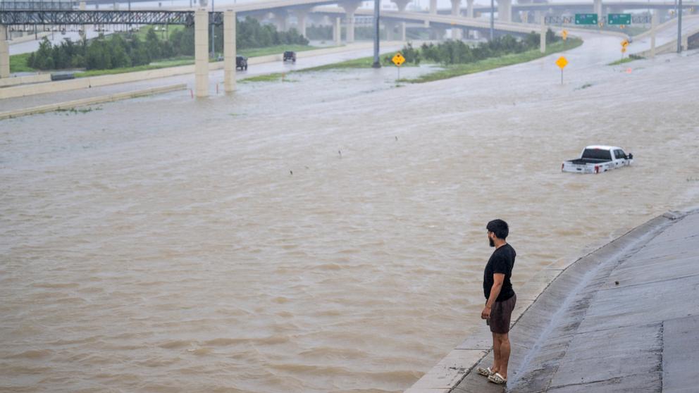 PHOTO: A person looks out towards the flooded interstate after Hurricane Beryl swept through the area on July 08, 2024 in Houston, Texas.