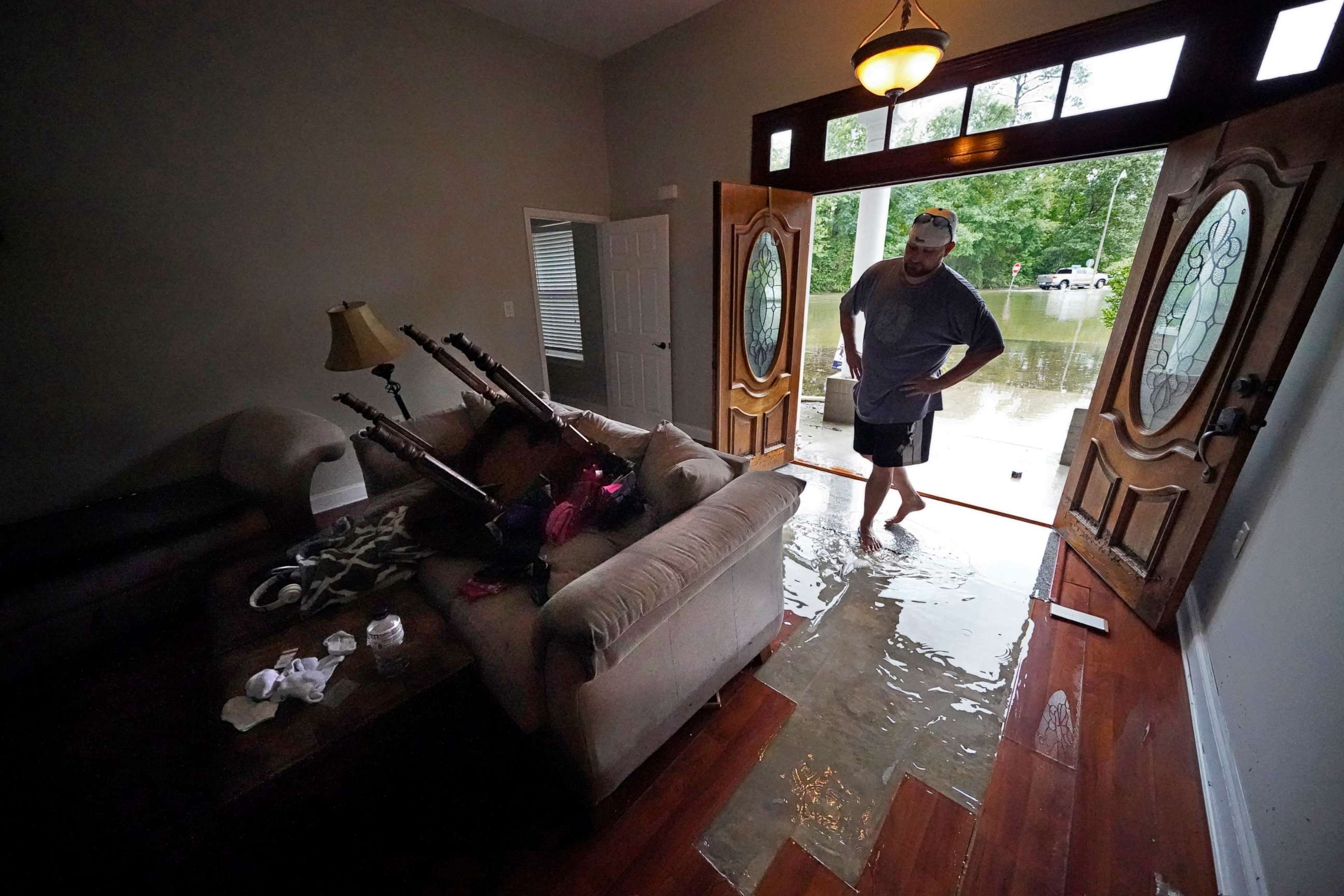 PHOTO: Danny Gonzales, walks in his flooded house as water recedes, after Tropical Storm Claudette passed through, in Slidell, La., June 19, 2021.