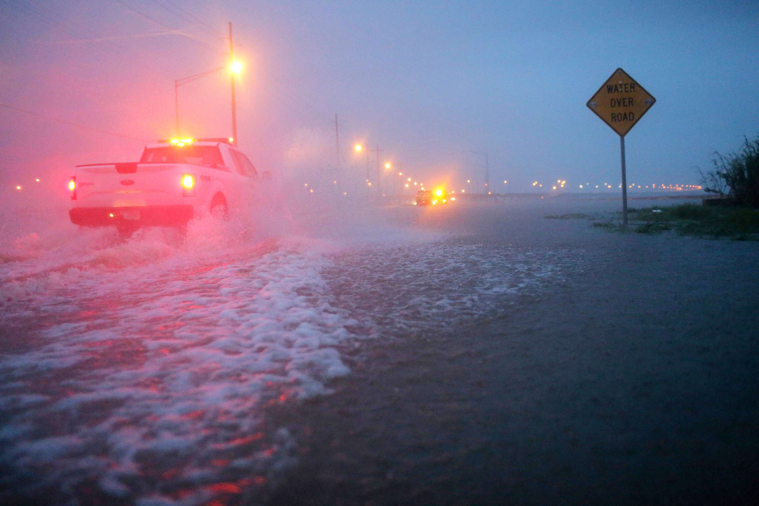 PHOTO: Trucks with the Alabama Department of Transportation work to block off a flooded part of US Highway 98 while fighting rain from Tropical Storm Gordon, Sept. 5, 2018, in Spanish Fort, Ala.