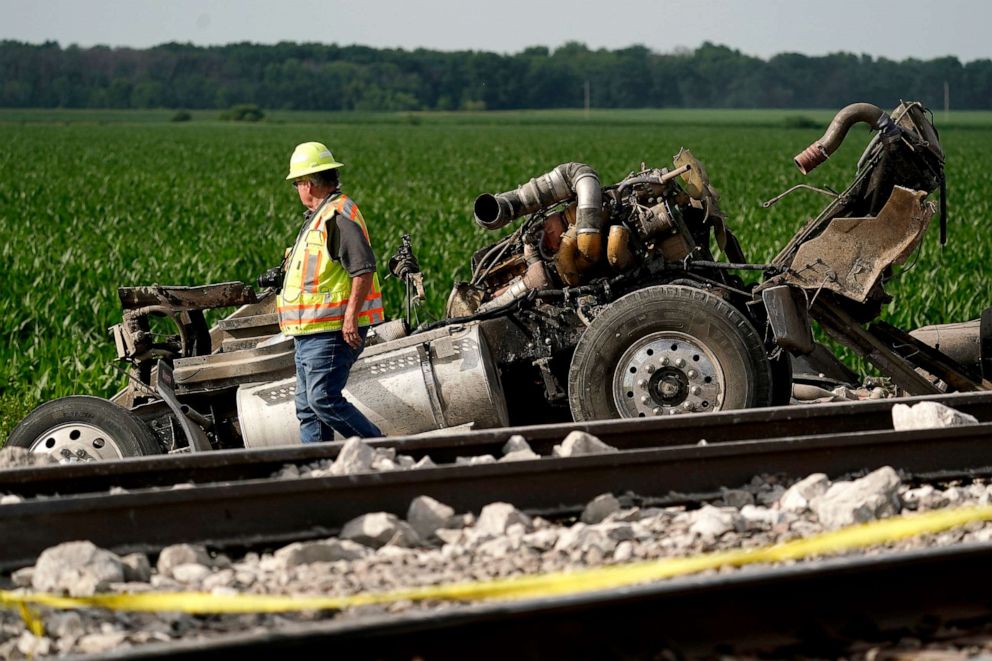 PHOTO: A worker looks over a dump truck that collided with an Amtrak train, causing it to derail, June 27, 2022, near Mendon, Mo.