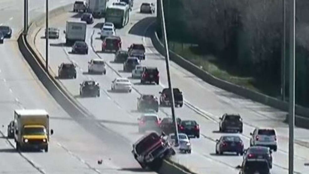 Out-of-control truck smashes light poles after climbing highway median ...