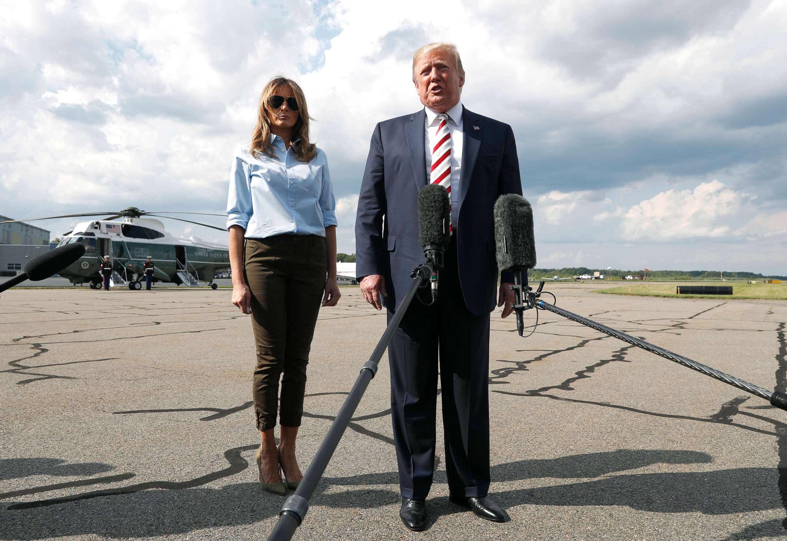 PHOTO: President Donald Trump, with first lady Melania Trump, speaks to the media before boarding Air Force One in Morristown, N.J., Aug. 4, 2019. 