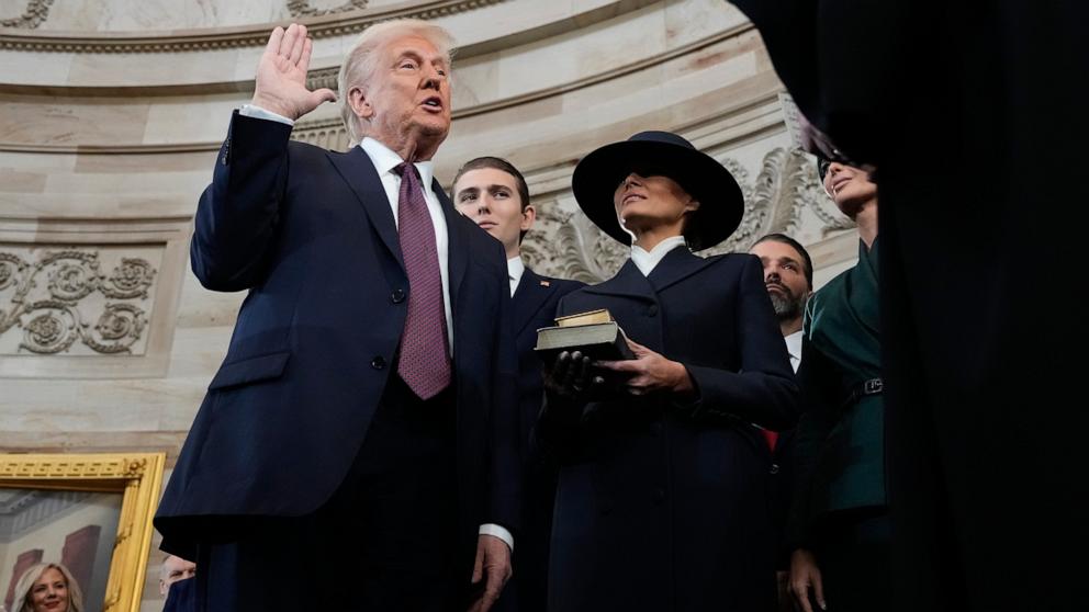 Donald Trump is sworn in as the 47th president of the United States by Chief Justice John Roberts as Melania Trump holds the Bible during the 60th Presidential Inauguration in the Rotunda of the Capitol, Jan. 20, 2025.Trump Inauguration