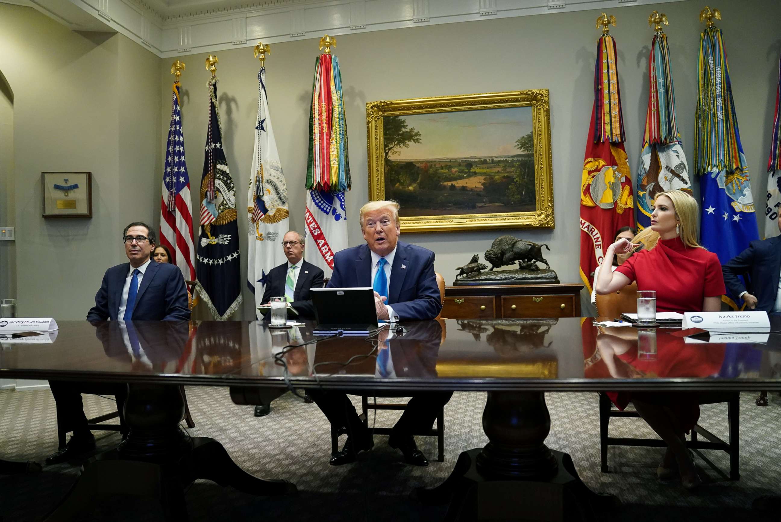 PHOTO: President Donald Trump, flanked by Treasury Secretary Steven Mnuchin and his daughter and senior advisor Ivanka Trump, participates in a "small business relief update" conference in the Roosevelt Room at the White House, April 7, 2020.