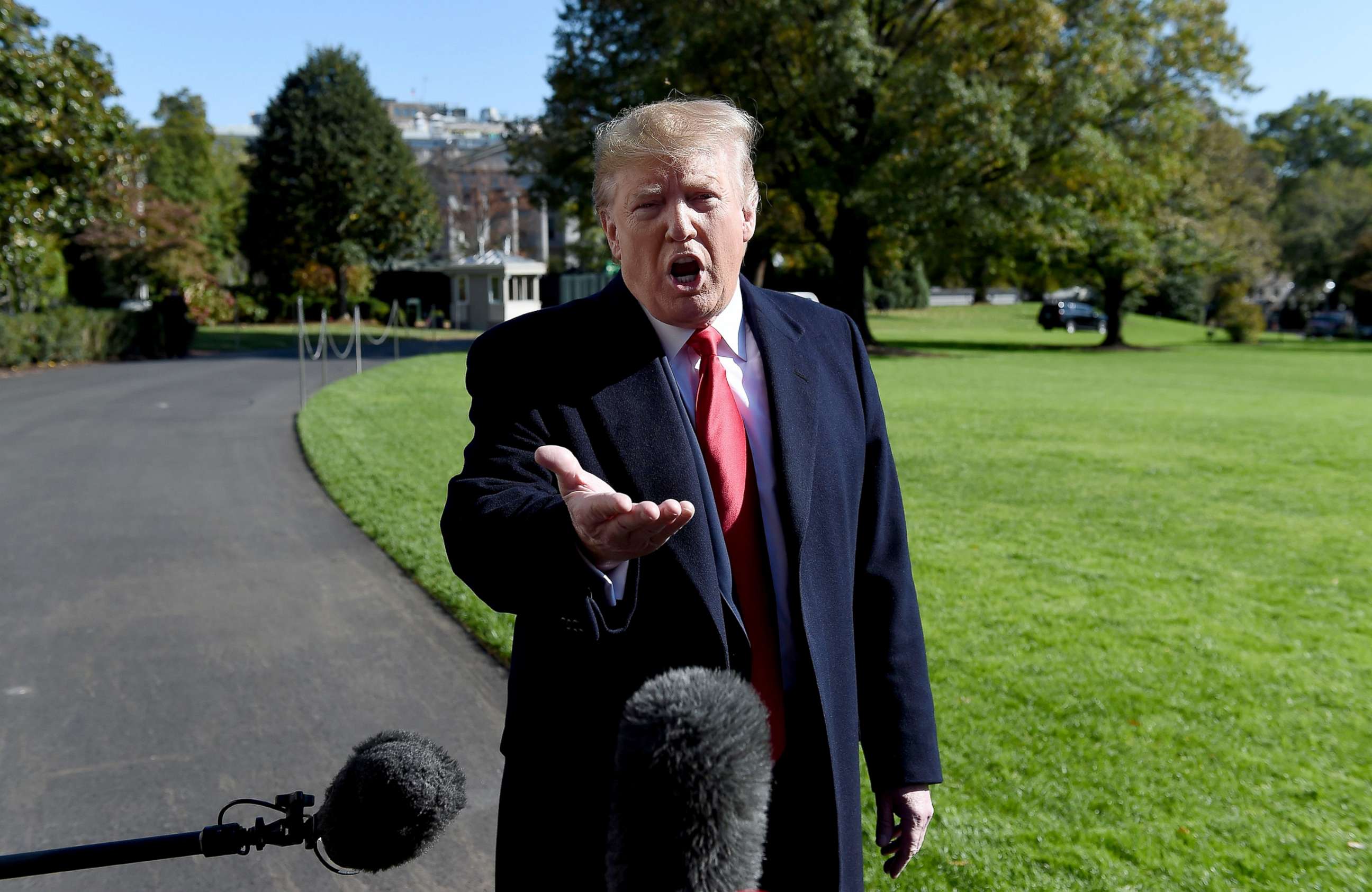 PHOTO: President Donald Trump talks to the media on the South Lawn upon his return to the White House, Nov. 3, 2019.