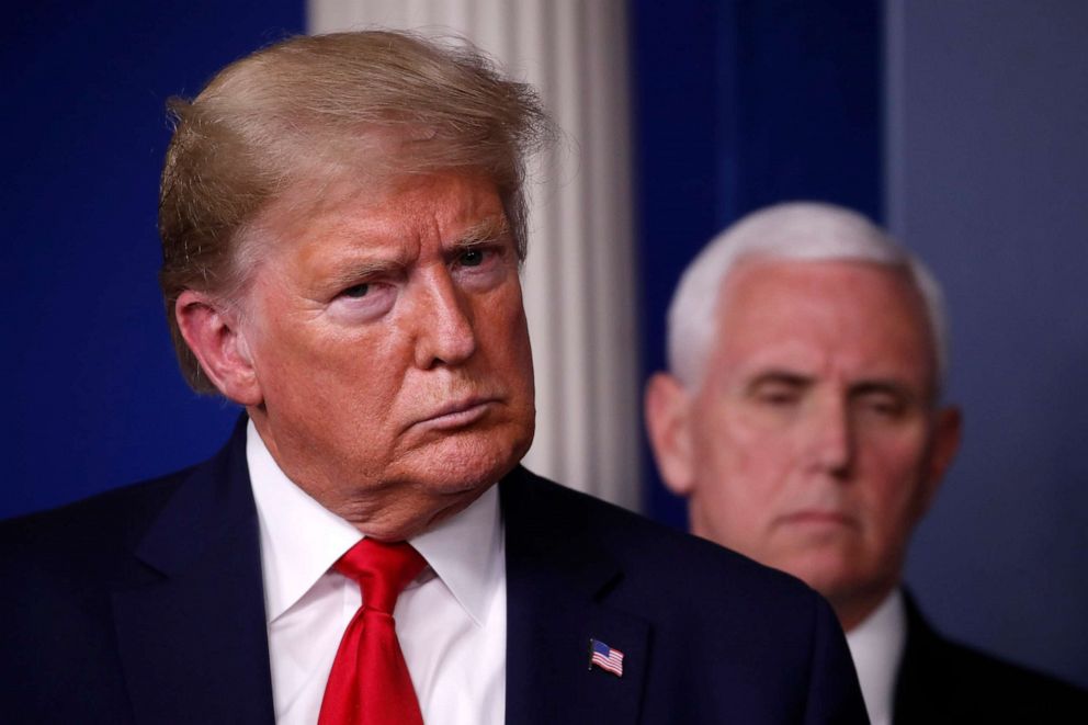 PHOTO: President Donald Trump and Vice President Mike Pence listen during a briefing about the coronavirus in the James Brady Briefing Room, March 24, 2020, in Washington.