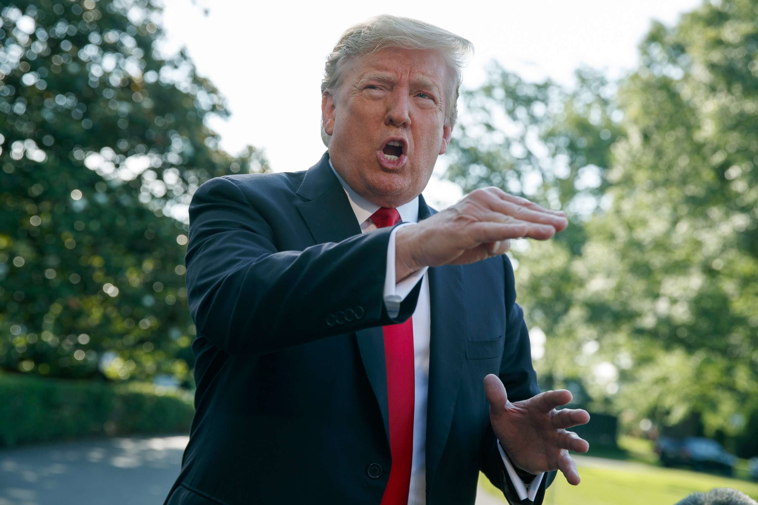 PHOTO: President Donald Trump talks with reporters on the South Lawn of the White House, May 30, 2019.
