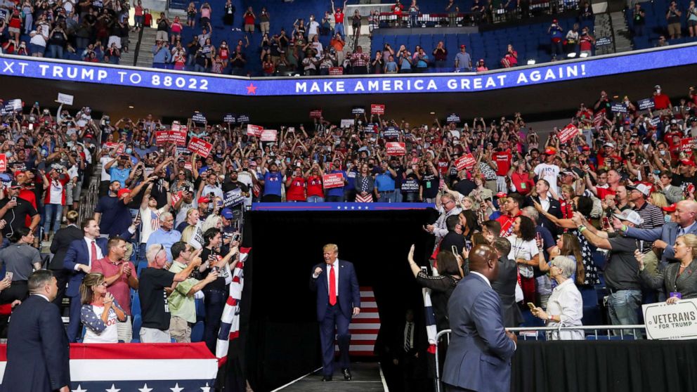 PHOTO: President Donald Trump pumps his fist as he enters his first re-election campaign rally in several months in the midst of the coronavirus disease (COVID-19) outbreak, at the BOK Center in Tulsa, Oklahoma, June 20, 2020.