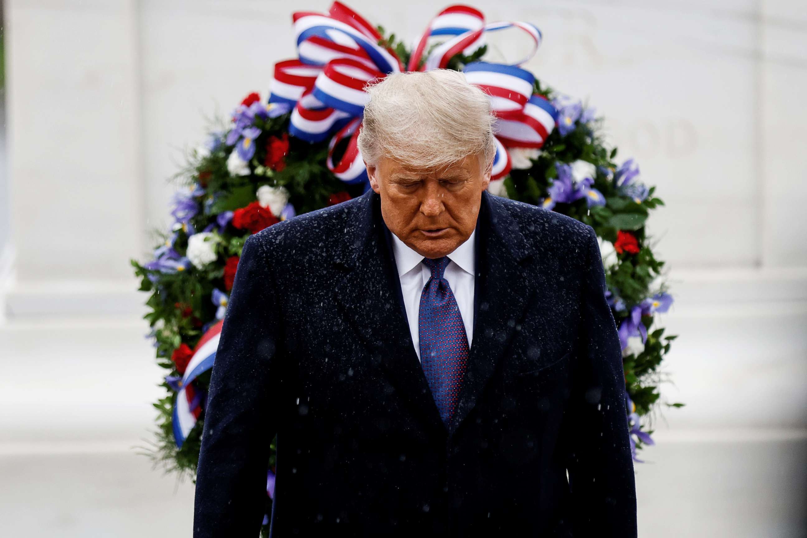 PHOTO: President Donald Trump turns away in the rain after laying a wreath at the Tomb of the Unknown Solider as he attends a Veterans Day observance in Arlington National Cemetery in Arlington, Va., Nov. 11, 2020.