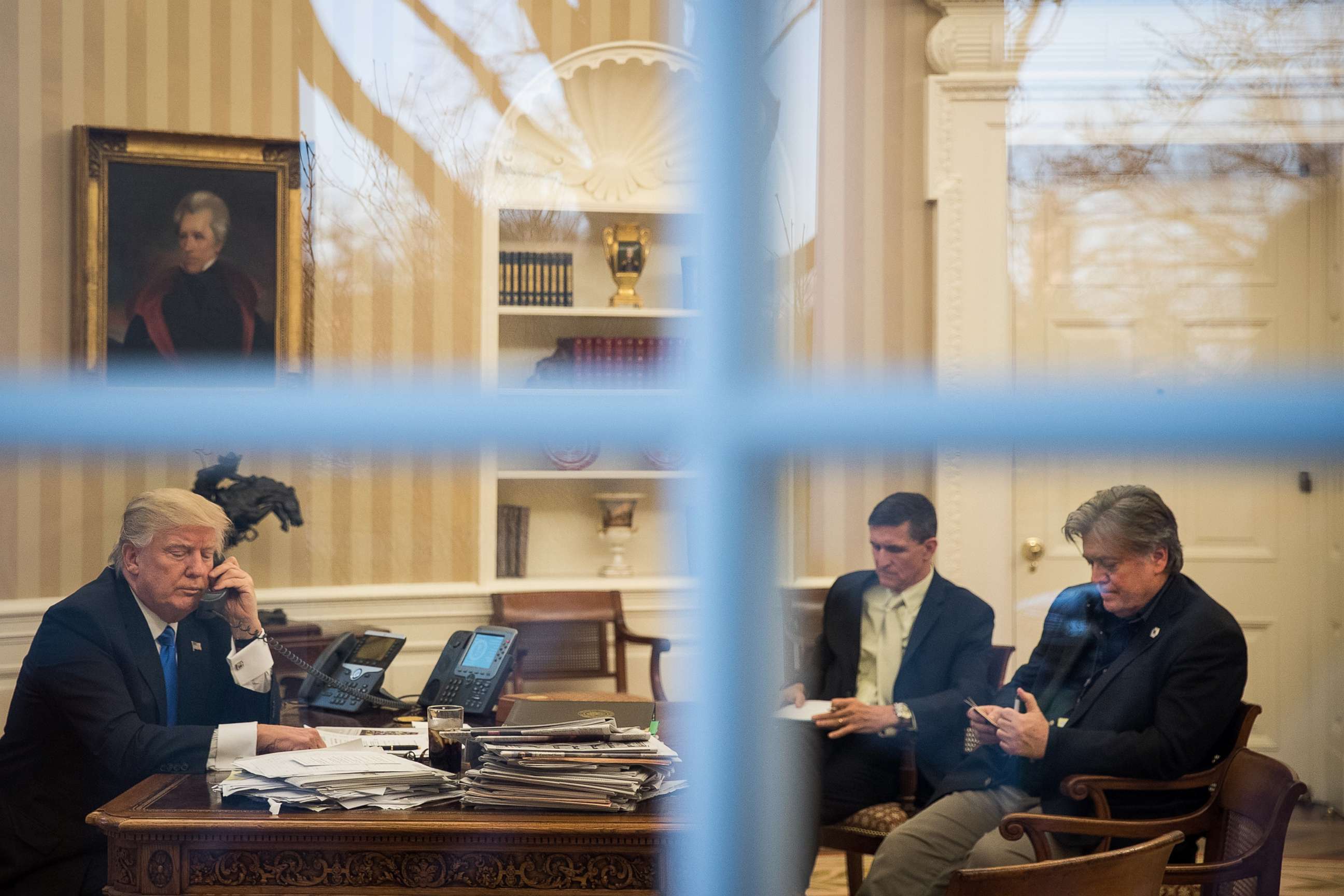 PHOTO: In this Jan. 28, 2017, file photo, President Donald Trump speaks on the phone in the Oval Office of the White House in Washington, D.C., as National Security Advisor Michael Flynn and White House Chief Strategist Steve Bannon look on.