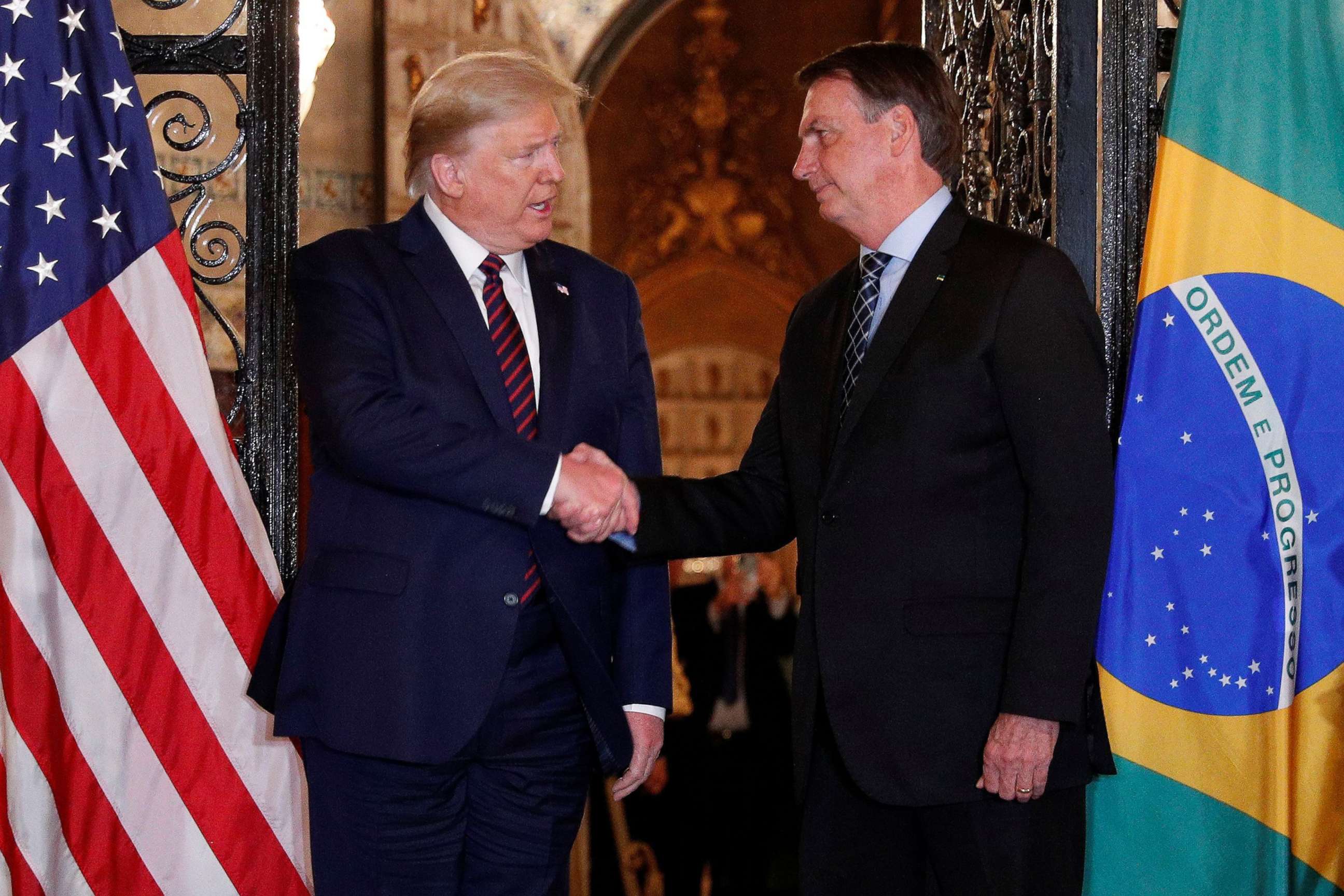 PHOTO: President Donald Trump shakes hands with Brazilian President Jair Bolsonaro before attending a working dinner at the Mar-a-Lago resort in Palm Beach, Fla., March 7, 2020. 