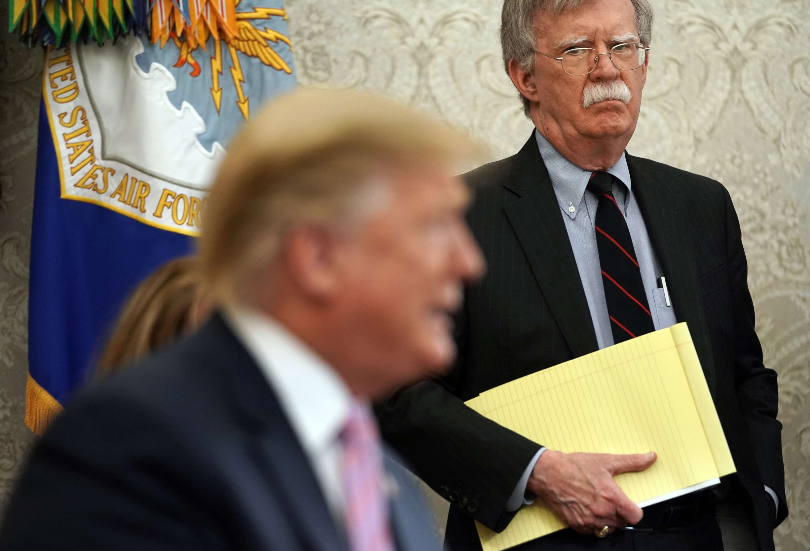 PHOTO: National Security Adviser John Bolton listens to U.S. President Donald Trump speak in the Oval Office of the White House, April 9, 2019, in Washington.