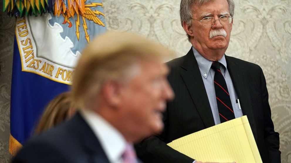PHOTO: National Security Adviser John Bolton listens to U.S. President Donald Trump speak in the Oval Office of the White House, April 9, 2019, in Washington.
