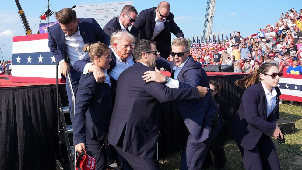 PHOTO: Former president Donald Trump is assisted offstage during a campaign rally at the Butler Farm Show Inc., July 13, 2024, in Butler, Pa.