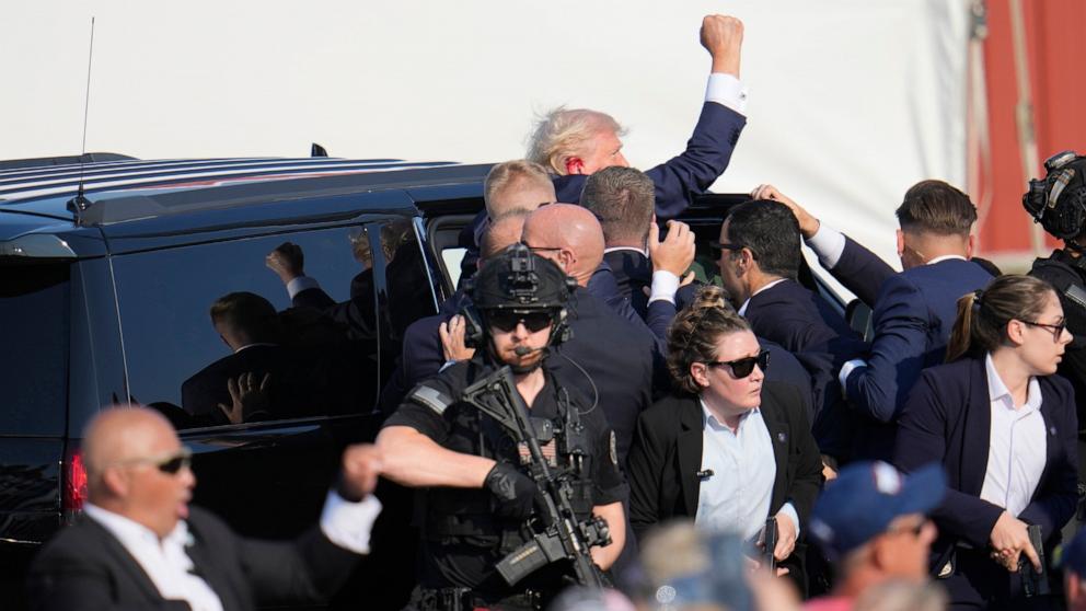 PHOTO: Republican presidential candidate former President Donald Trump pumps his fist as he is helped into a vehicle at a campaign event in Butler, Pa., on July 13, 2024. 