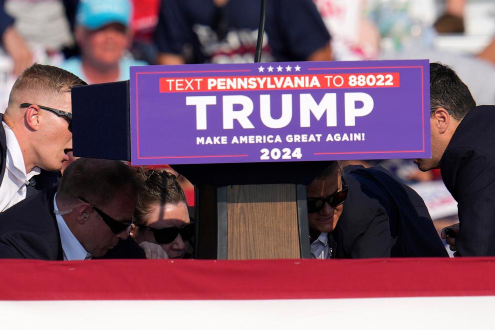 PHOTO: Members of the U.S. Secret Service surround Republican presidential candidate former President Donald Trump at a campaign event in Butler, Pa., on July 13, 2024.