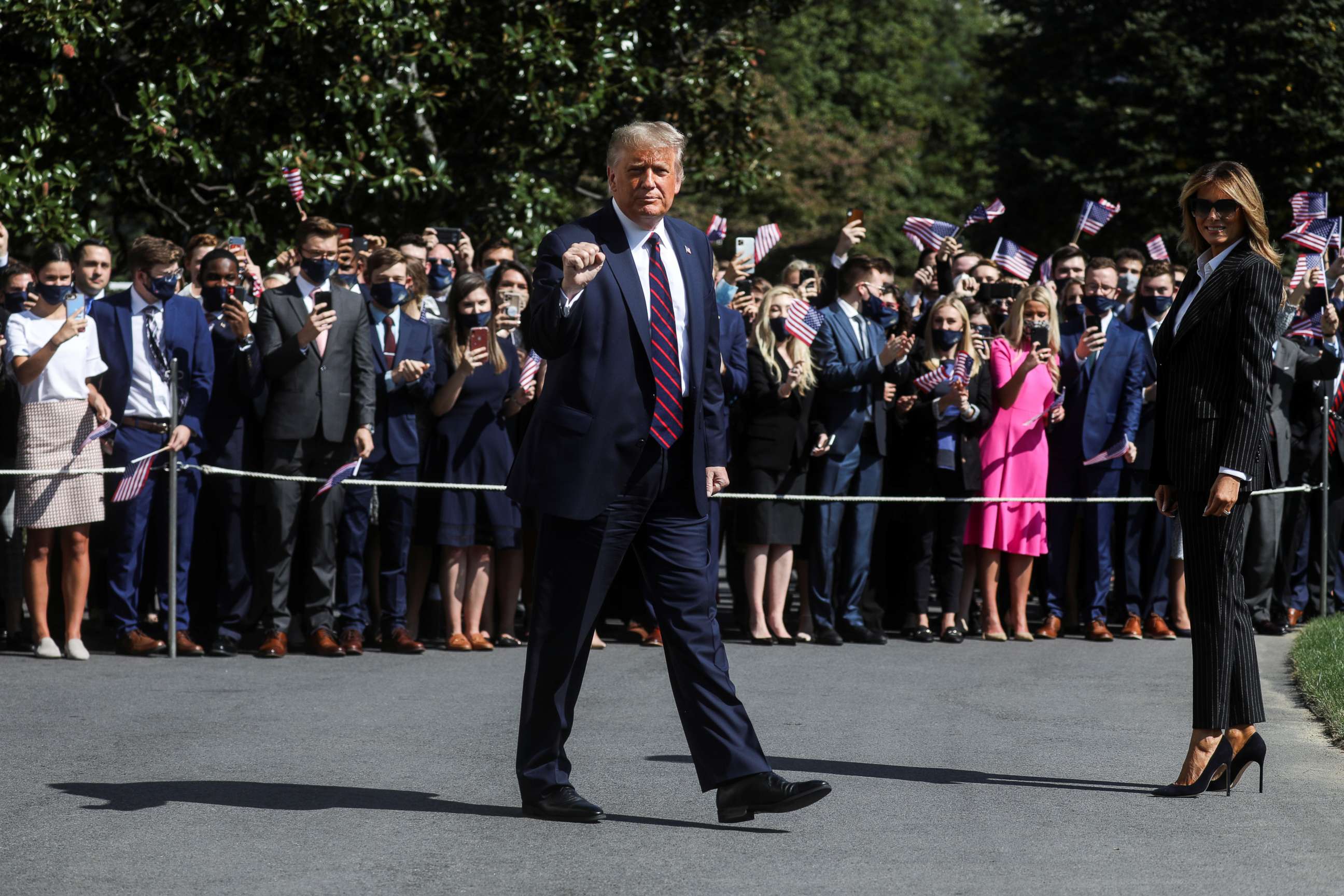 PHOTO: President Donald Trump gestures to reporters as he departs with first lady Melania Trump to participate in his first presidential debate with Democratic presidential nominee Joe Biden in Cleveland, from Washington, Sept. 29, 2020.