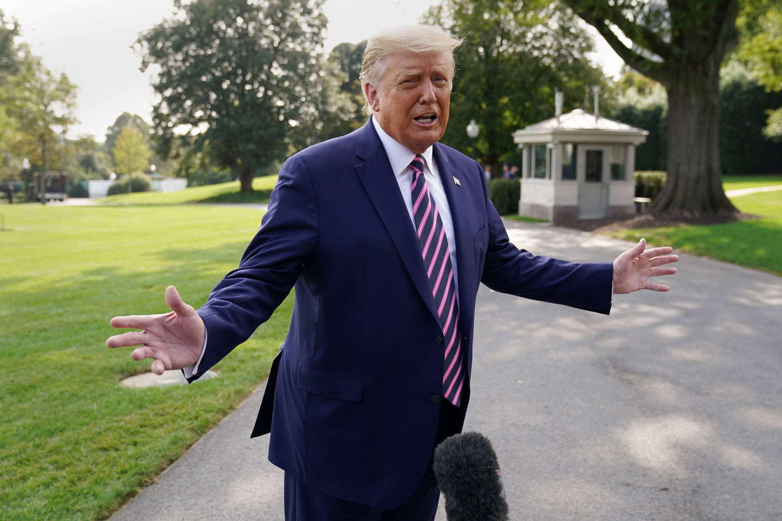 PHOTO: President Donald Trump talks to reporters as he departs for campaign travel to Minnesota from the South Lawn at the White House, Sept. 18, 2020.