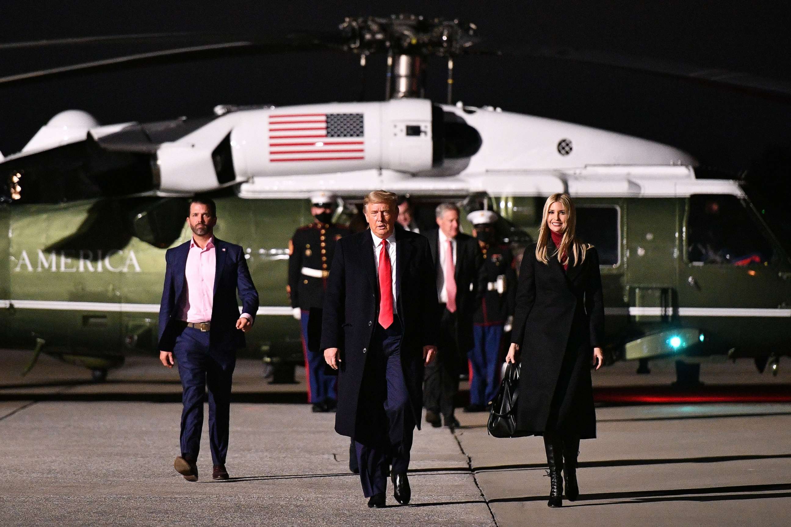 PHOTO: Donald Trump Jr., President Donald Trump and daughter Senior Advisor Ivanka Trump make their way to board Air Force One before departing from Dobbins Air Reserve Base in Marietta, Ga, Jan. 4, 2021.