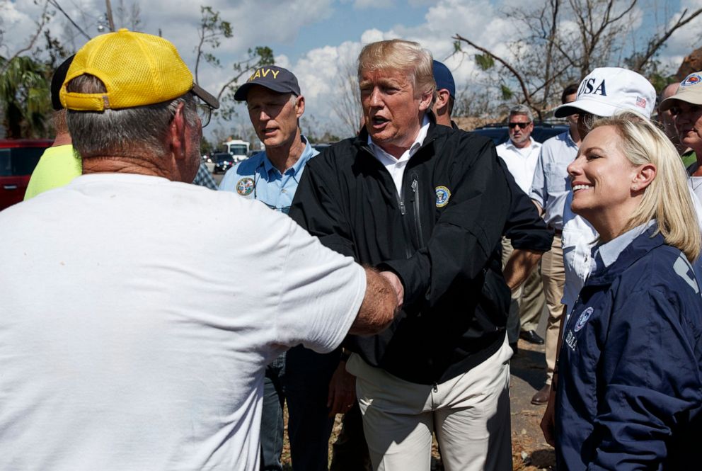 PHOTO: President Donald Trump greets a Lynn Haven, Fla. resident, left, during a tour of a neighborhood hit by Hurricane Michael, Oct. 15, 2018, in Lynn Haven, Fla. 