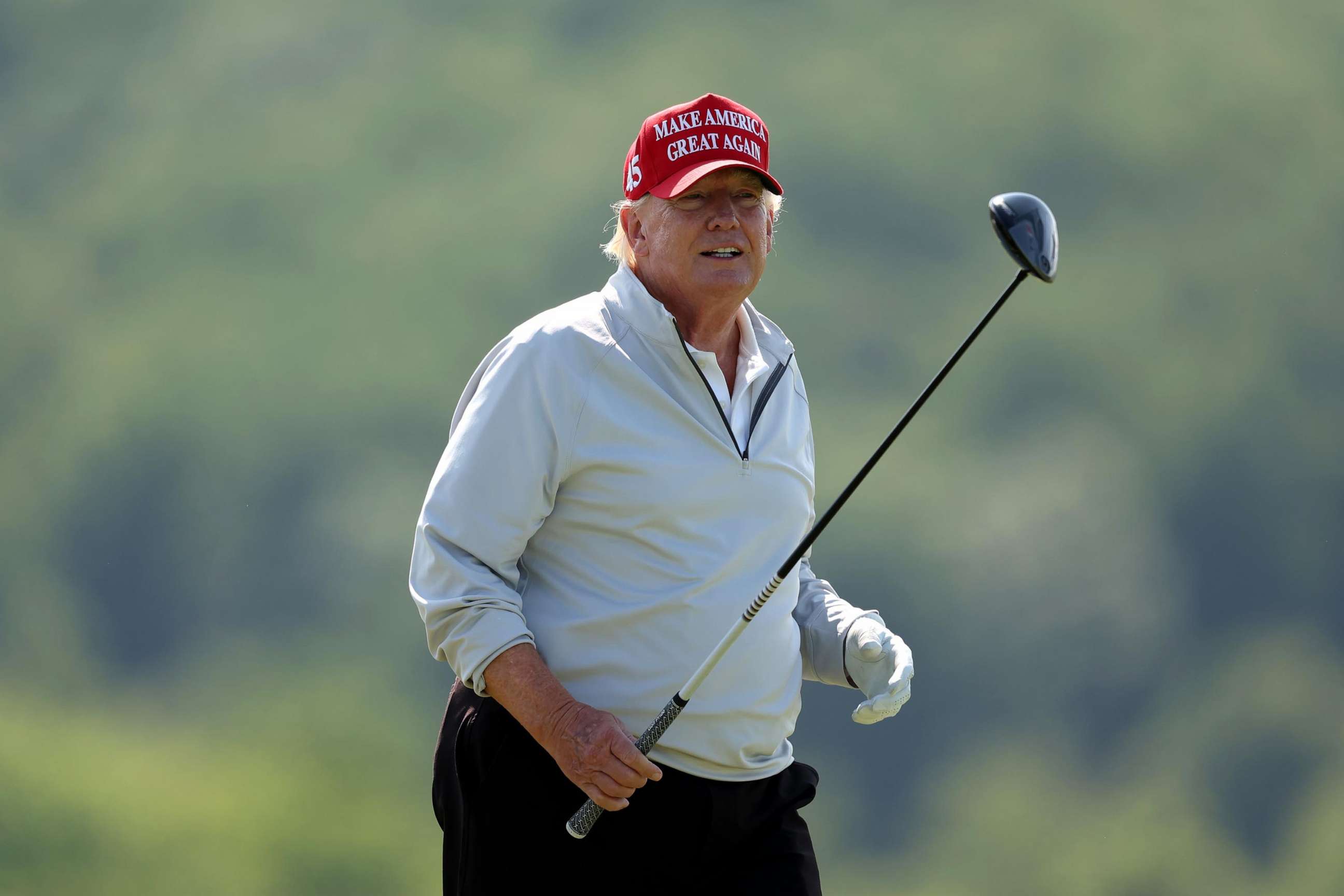 PHOTO: Former President Donald Trump follows his tee shot during the pro-am prior to the LIV Golf Invitational - DC at Trump National Golf Club on May 25, 2023, in Sterling, Virginia.