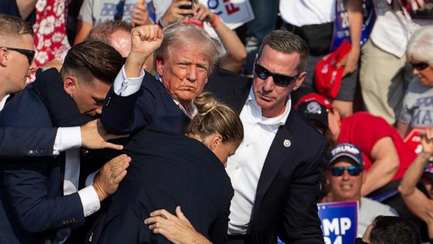 Republican candidate Donald Trump is seen with blood on his face surrounded by secret service agents as he is taken off the stage at a campaign event at Butler Farm Show Inc. in Butler, Pa., July 13, 2024. 
