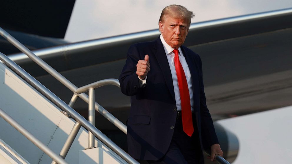 PHOTO: Former President Donald Trump gives a thumbs up as he arrives at Atlanta Hartsfield-Jackson International Airport, on Aug. 24, 2023, in Atlanta.