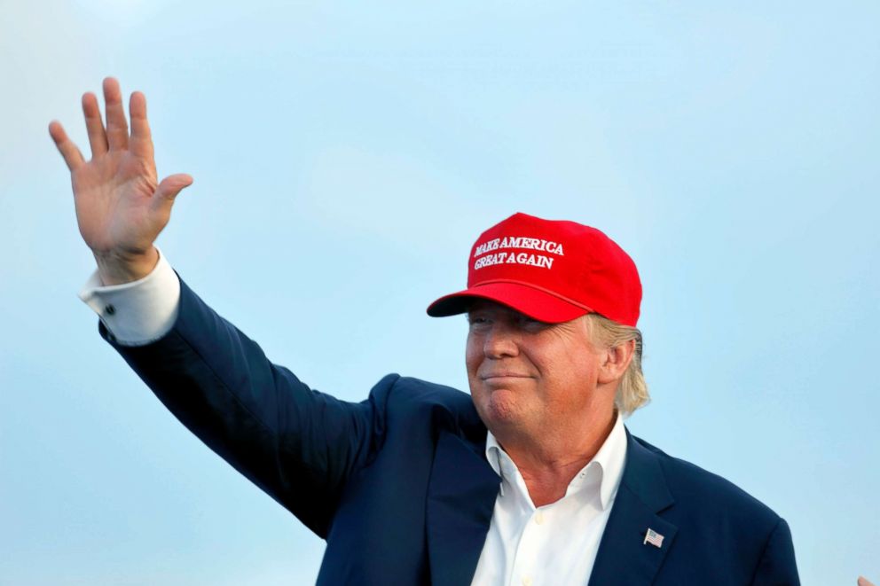 PHOTO: Donald Trump Waves During A Rally Aboard The Battleship USS Iowa in Los Angeles, while wearing a 'Make America Great Again' hat, Sept. 15, 2015.