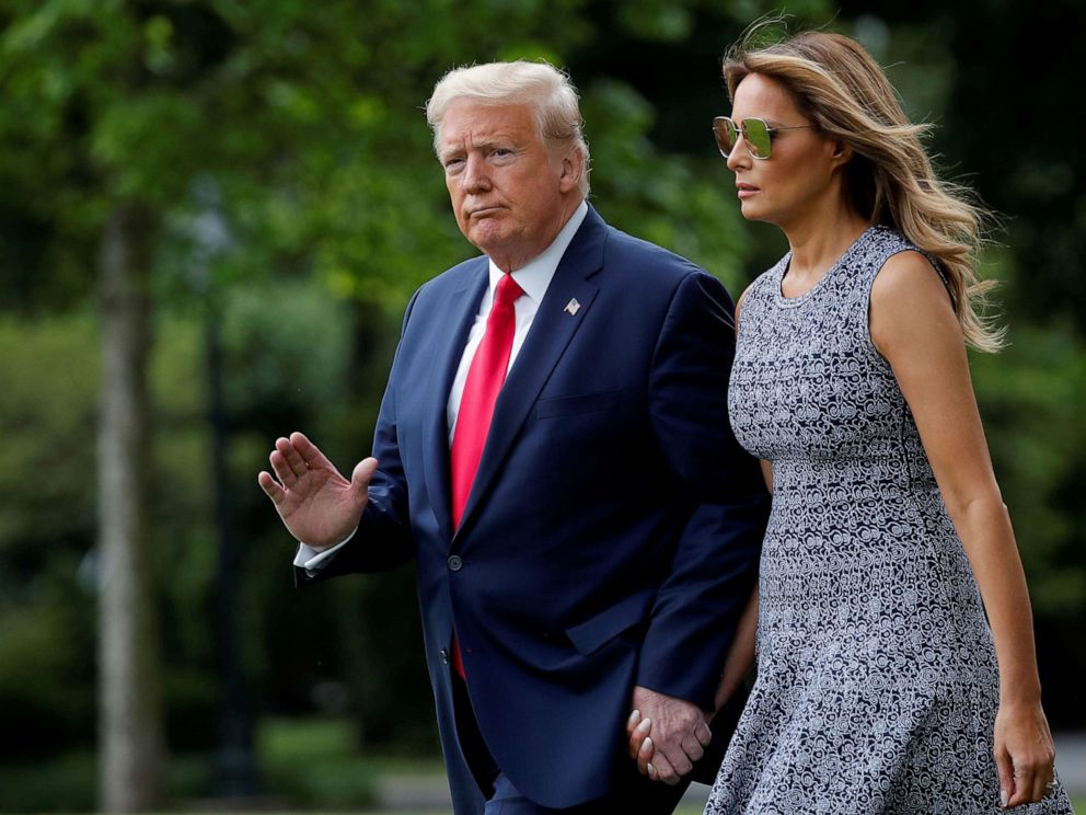 PHOTO: President Donald Trump walks with first lady Melania Trump as they depart for travel to the Kennedy Space Center in Florida from the South Lawn at the White House, May 27, 2020.