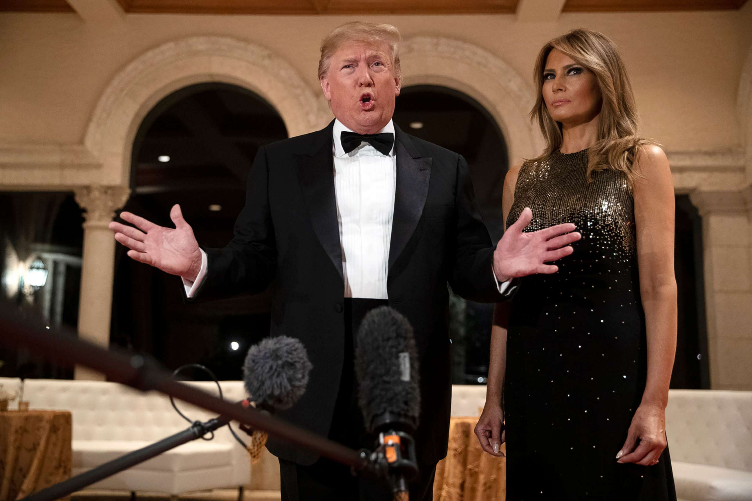 PHOTO: First lady Melania Trump listens as President Donald Trump speaks to reporters before his New Year's Eve party at his Mar-a-Lago property, Dec. 31, 2019, in Palm Beach, Fla.
