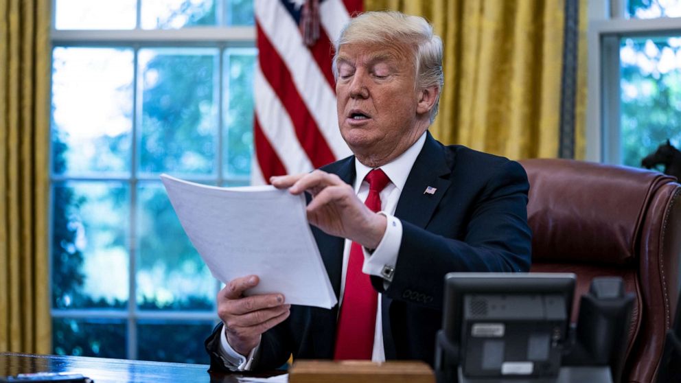 PHOTO: President Donald Trump reviews papers during an interview in the Oval Office of the White House in Washington, D.C., Aug. 30, 201