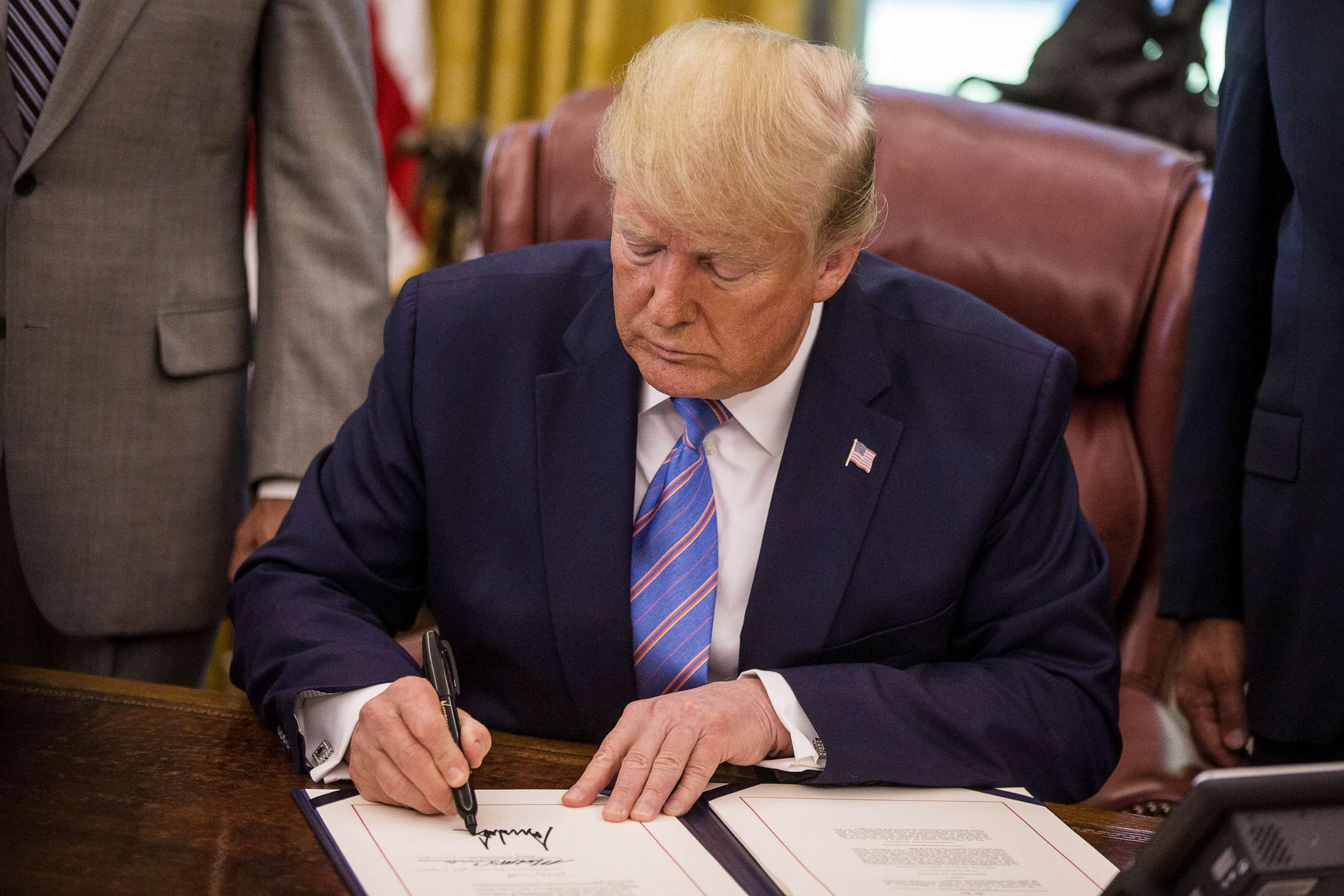 PHOTO: FILE - U.S. President Donald Trump signs H.R. 3151, the Taxpayer First Act, during a ceremony in the Oval Office of the White House in Washington, D.C., July 1, 2019.