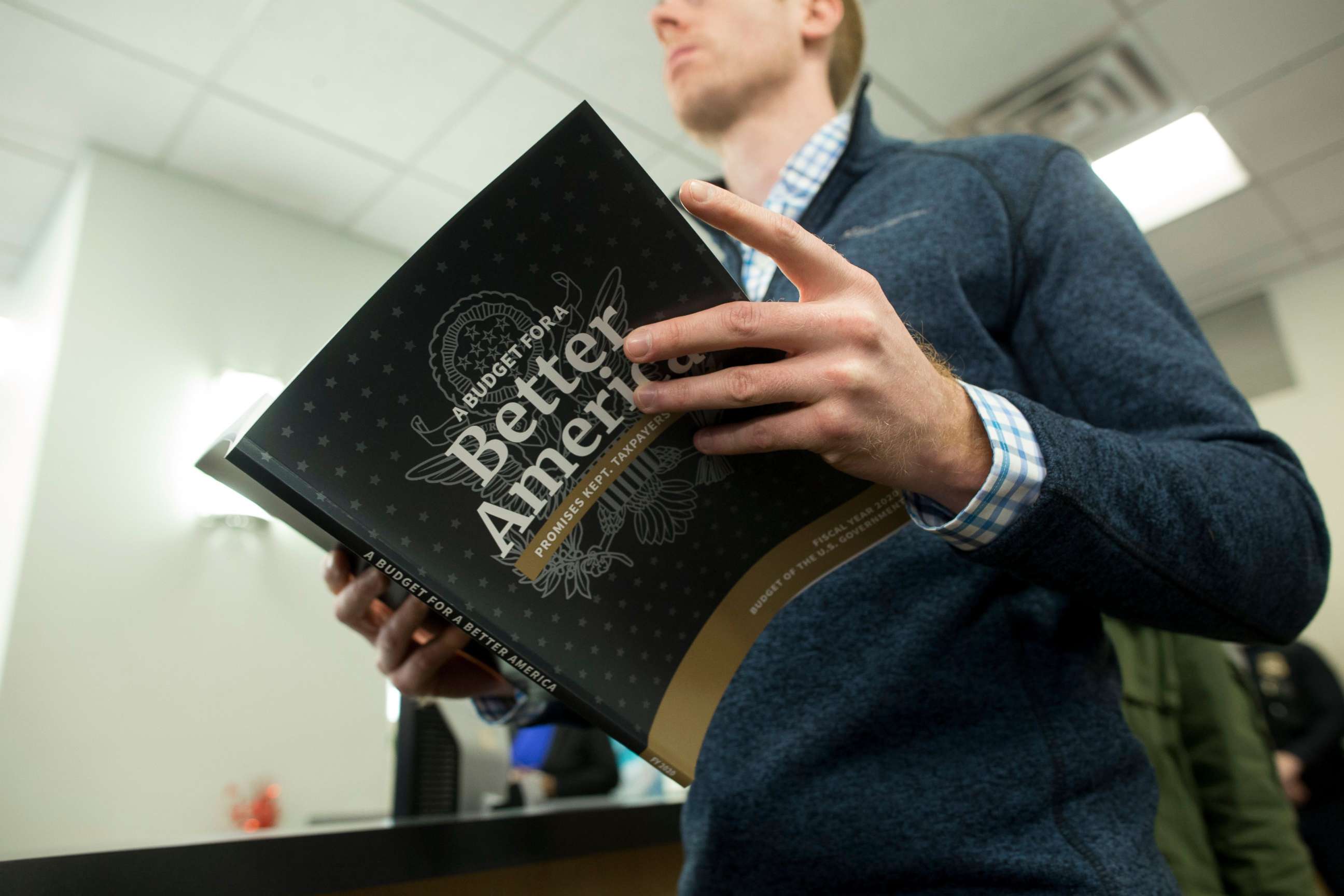 PHOTO: A member of the public waits in line to purchase a copy of President Donald Trump's budget for the fiscal year 2020, at it's release at the Government Publishing Office bookstore in Washington, March 11, 2019.