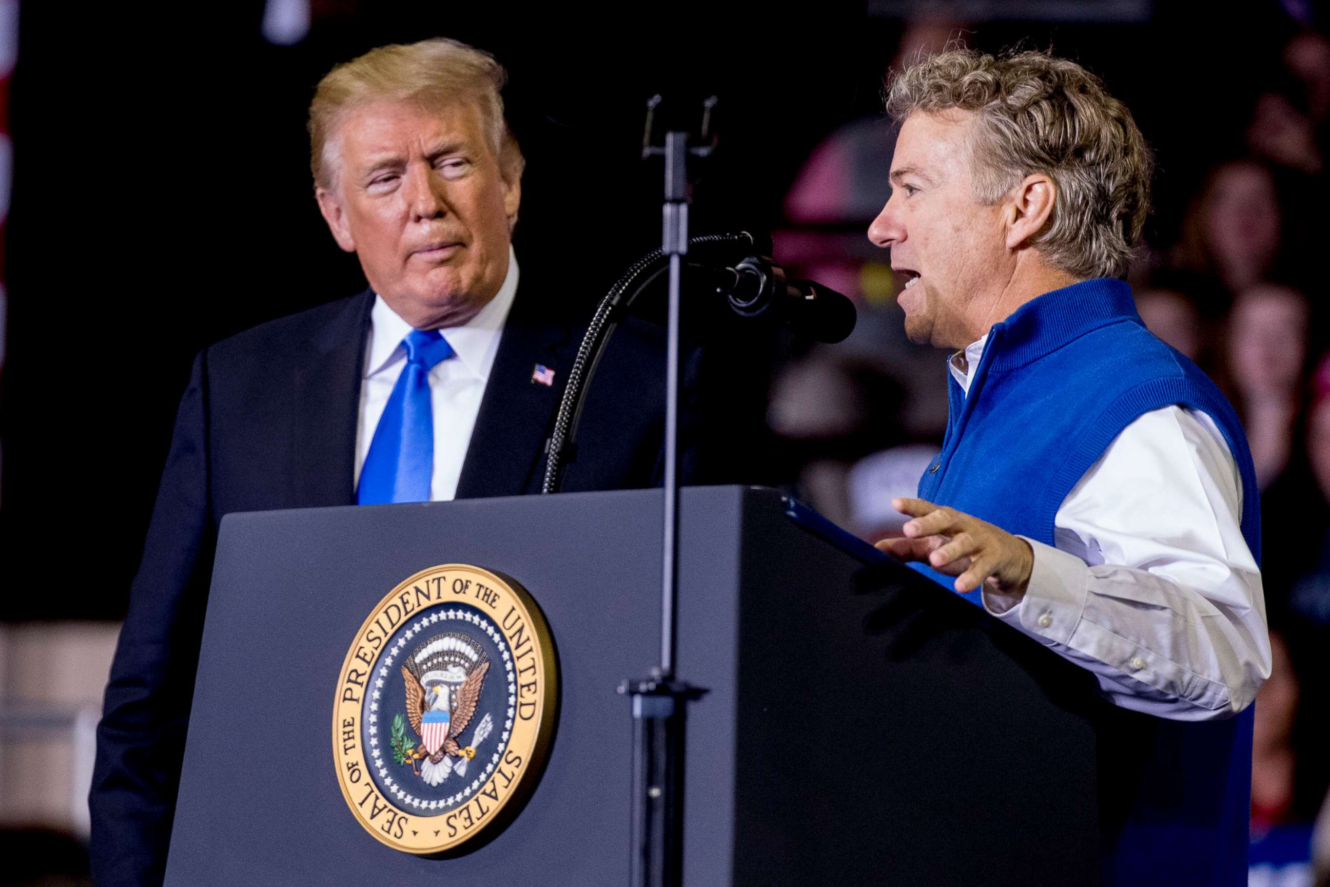 PHOTO: President Donald Trump, left, listens as Sen. Rand Paul, right, speaks at a rally at Alumni Coliseum in Richmond, Ky., Oct. 13, 2018