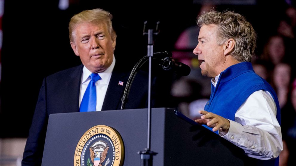 PHOTO: President Donald Trump, left, listens as Sen. Rand Paul, right, speaks at a rally at Alumni Coliseum in Richmond, Ky., Oct. 13, 2018