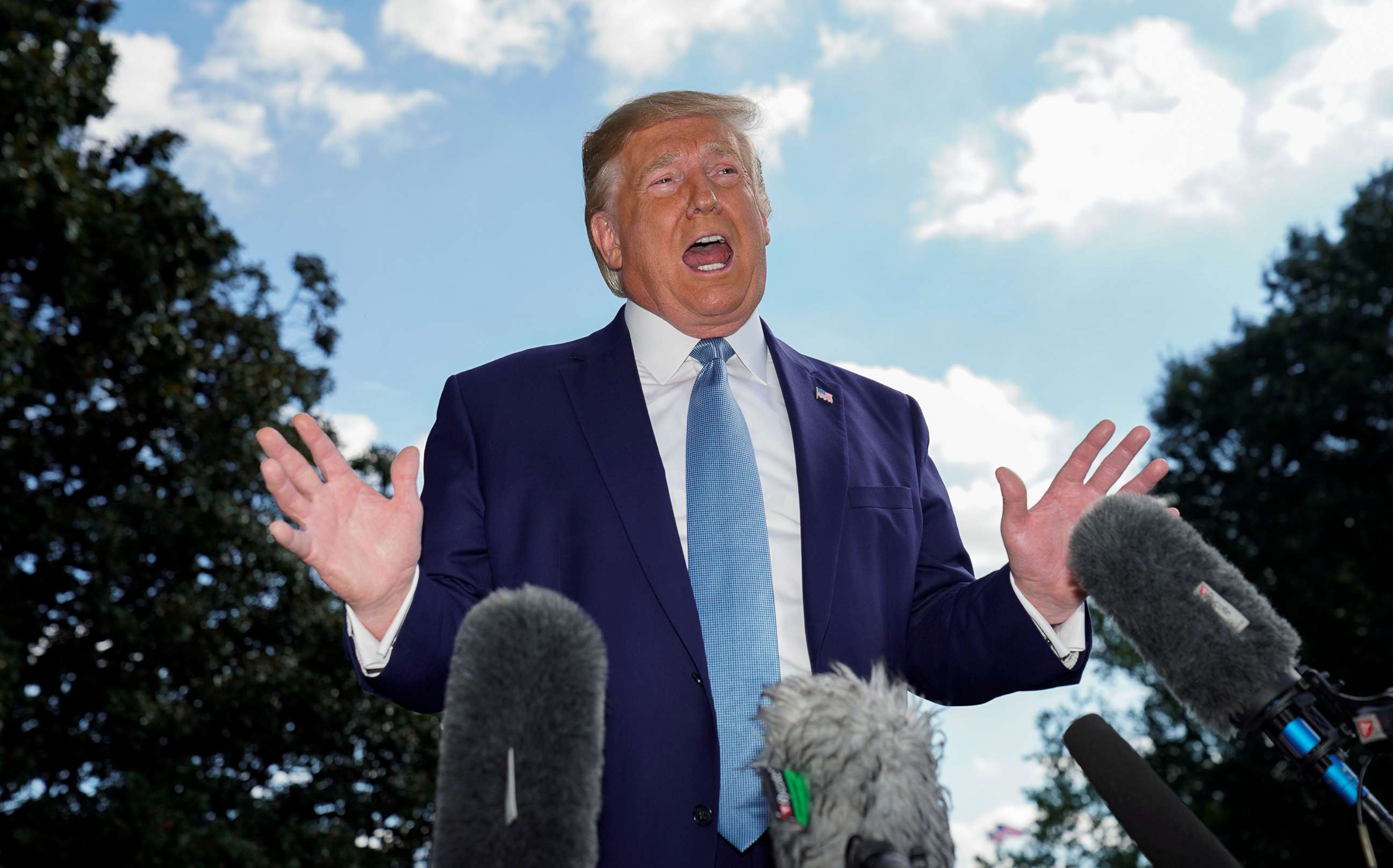 PHOTO: President Donald Trump talks to reporters as he heads to the Marine One helicopter to fly to visit injured members of the U.S. military at Walter Reed National Military Medical Center from the White House in Washington, Oct. 4, 2019.