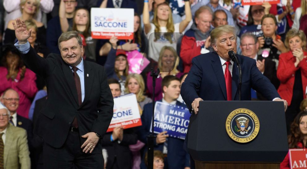PHOTO: Rick Saccone waves while President Donald Trump speaks to supporters at the Atlantic Aviation Hanger on March 10, 2018 in Moon Township, Pa.