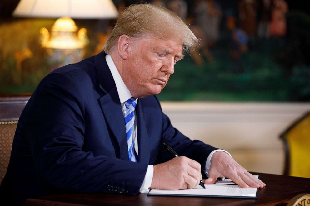 PHOTO: President Donald Trump signs a presidential memorandum at the White House in Washington D.C., on May 8, 2018, He said that the United States will withdraw from the Iran nuclear deal, a landmark agreement signed in 2015.